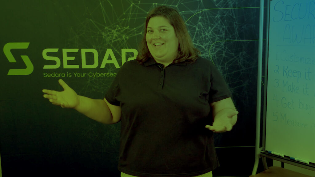 Sedara Team Member standing in front of a whiteboard, ready to present or discuss cybersecurity strategies.